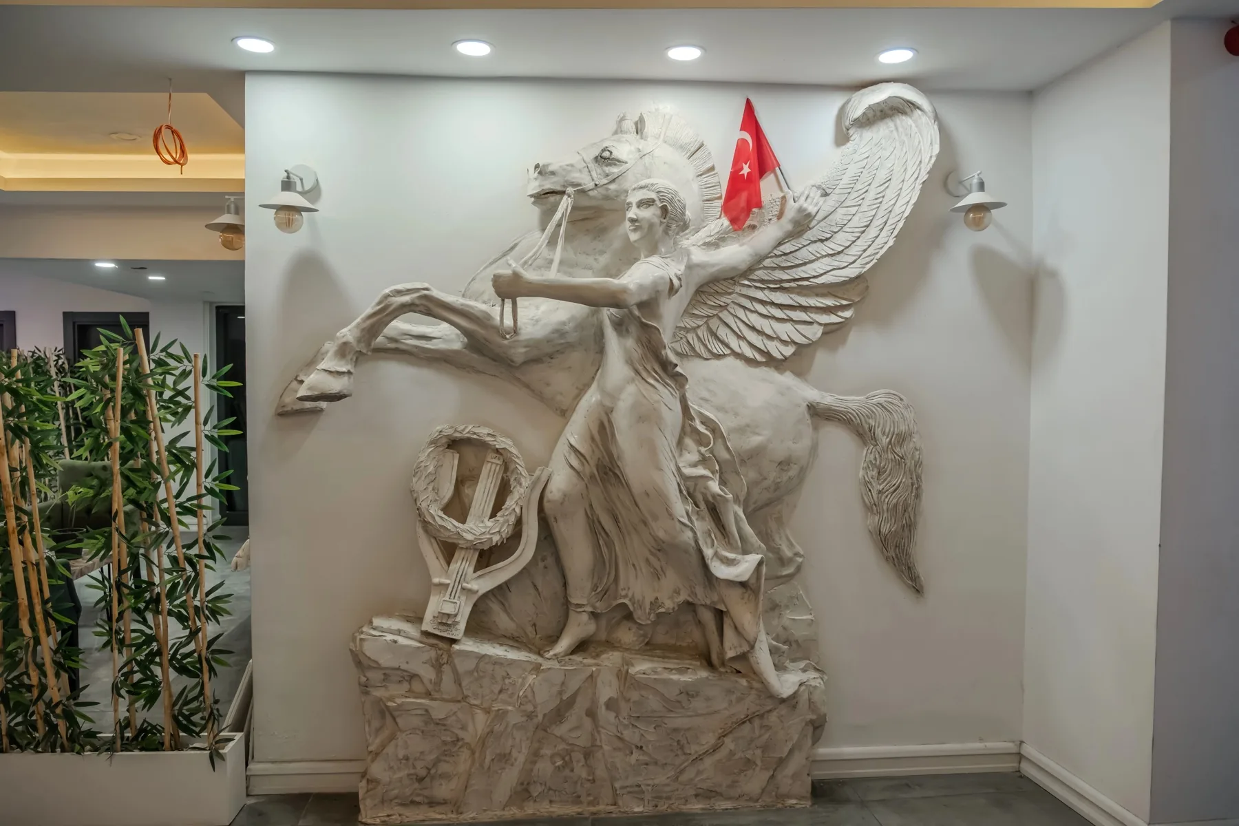 Mİ Hotel Boutique — Dekoratif at ve kanatlı figür kabartması